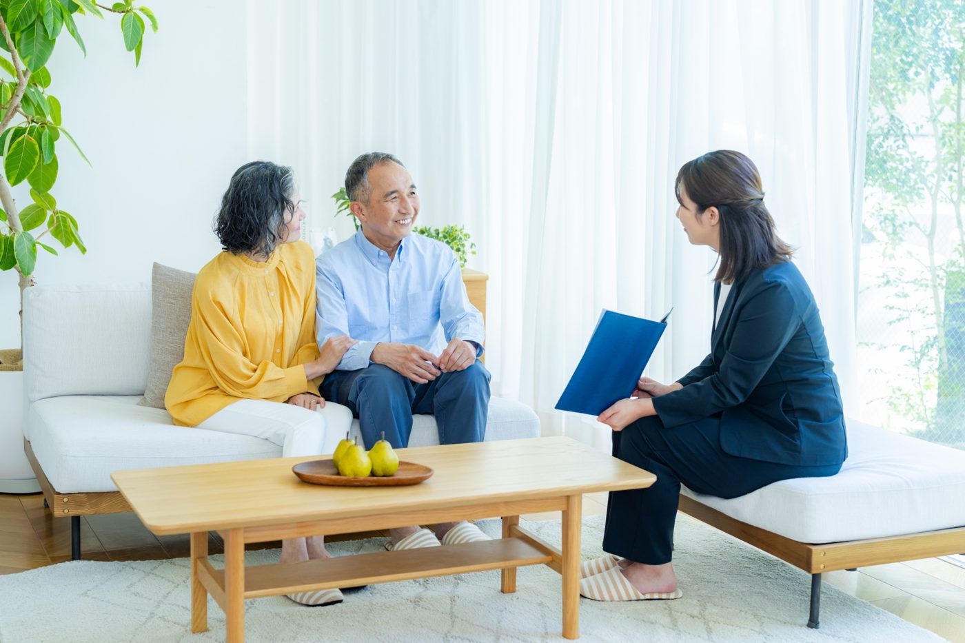 ソファで担当者と話す高齢のご夫婦